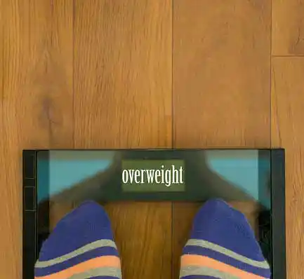 weighing scale displaying overweight